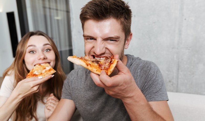 ピザを食べている真ん中っ子同士の夫婦